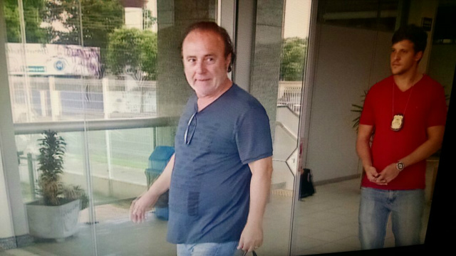 O empresário Mário Celso é escoltado por policiais federais ao sair do Fórum da Justiça Federal de Três Lagoas (Foto: Perfil News)