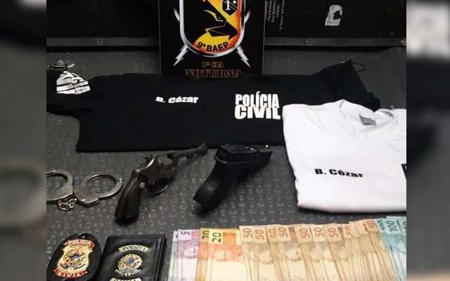 Com o suspeito foram encontradas duas armas, um revólver calibre 32, com quatro munições, um simulacro de pistola, um par de algemas, carteira e distintivo da Polícia Civil, duas camisetas com escritas da Polícia Civil e R$ 1,6 mil. Foto: Divulgação/DLnews